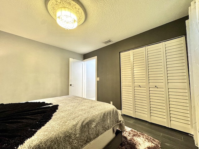 bedroom with dark wood-type flooring and a textured ceiling