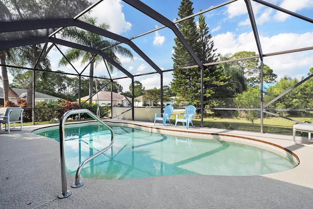 outdoor pool featuring a patio area and glass enclosure