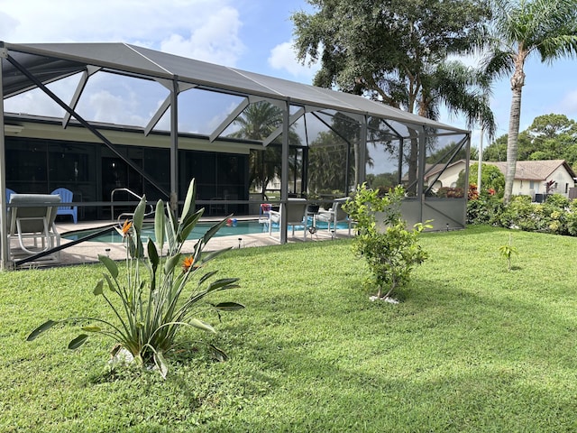 view of yard with a lanai and an outdoor pool