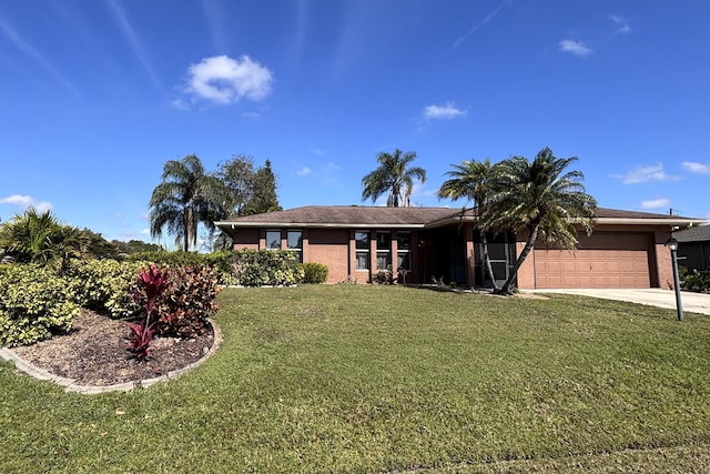 ranch-style home featuring an attached garage, concrete driveway, and a front yard