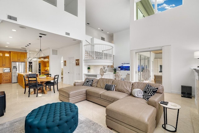 living room with crown molding and a high ceiling