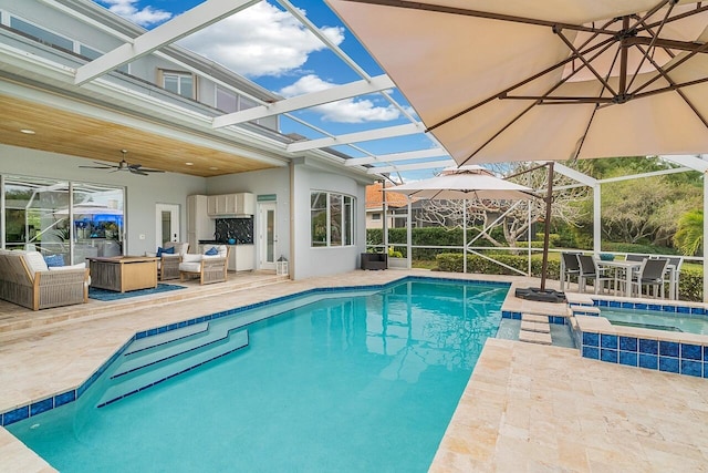 view of swimming pool with an in ground hot tub, a lanai, ceiling fan, an outdoor living space, and a patio area