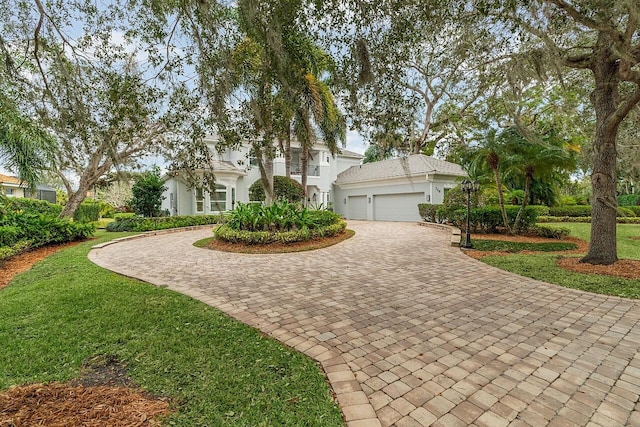 view of front of home featuring a garage and a front lawn