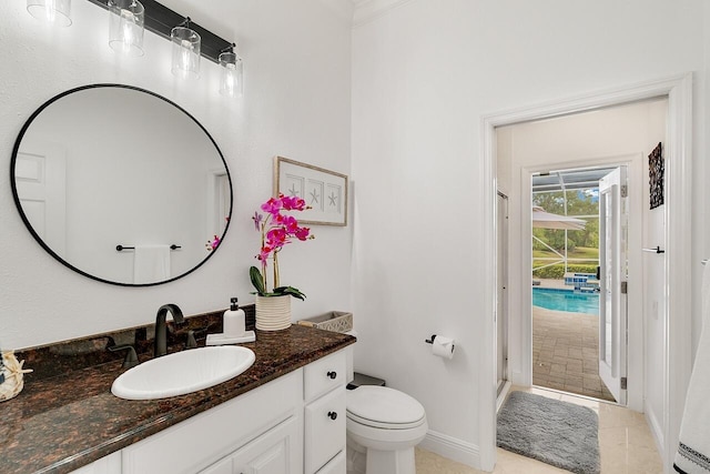 bathroom with an enclosed shower, vanity, tile patterned floors, and toilet