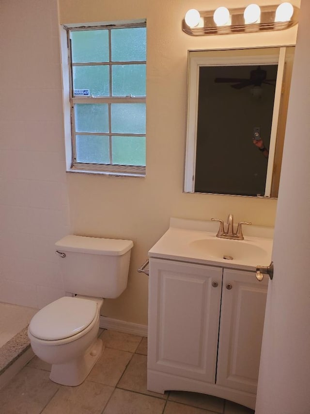 bathroom featuring vanity, tile patterned flooring, and toilet