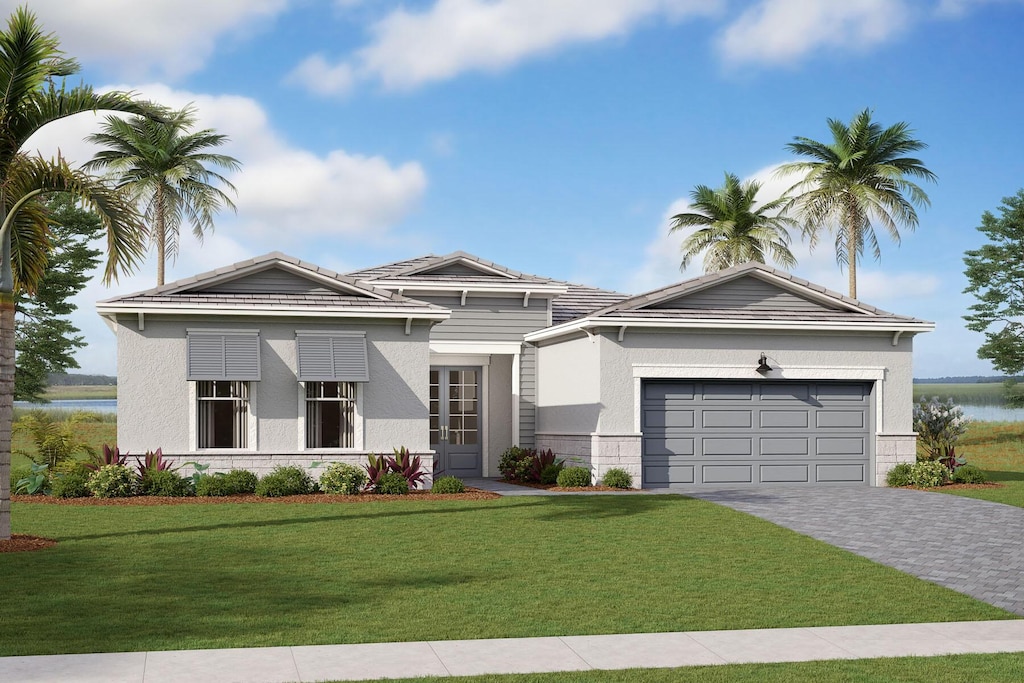 view of front of house with a garage and a front lawn