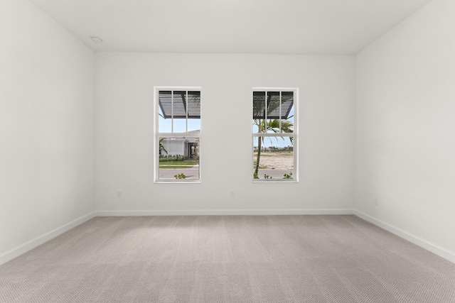 unfurnished room featuring baseboards and carpet flooring