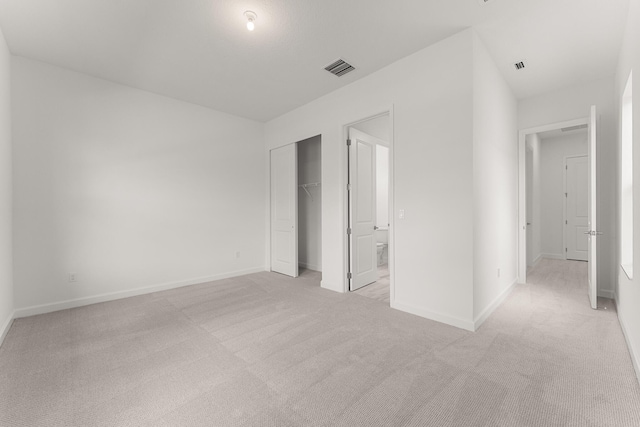 unfurnished bedroom featuring baseboards, visible vents, and light carpet