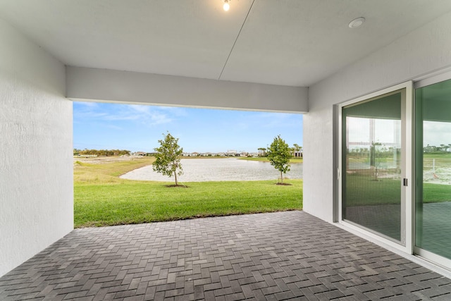 view of patio with a water view