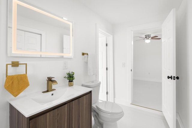 bathroom with vanity, ceiling fan, and toilet