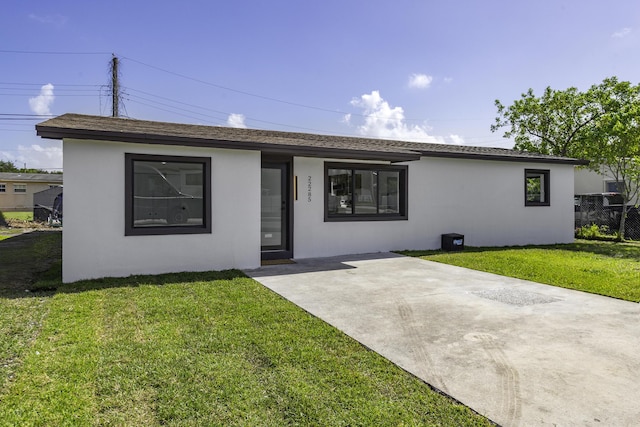 ranch-style house with a patio and a front yard