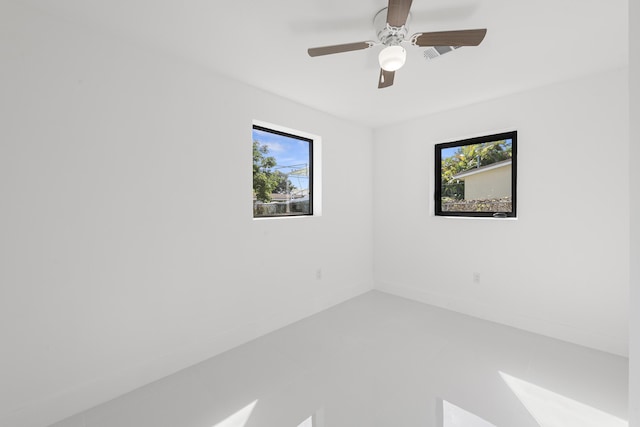 spare room with plenty of natural light and ceiling fan