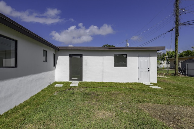 back of property featuring a lawn