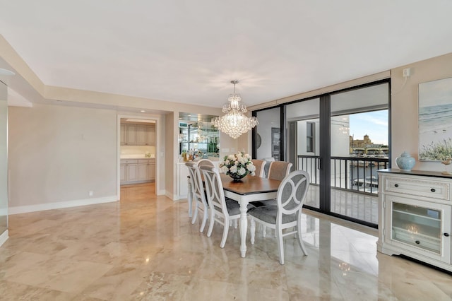 400 N Flagler Dr Unit 506, West Palm Beach, FL 33401 - dining area featuring a chandelier, light marble finish floors, and baseboards