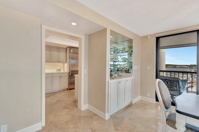 home office with expansive windows, baseboards, and recessed lighting