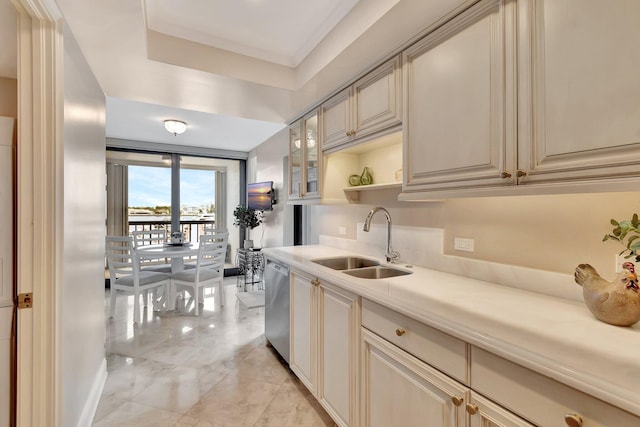 kitchen with cream cabinetry, light countertops, a sink, and dishwasher