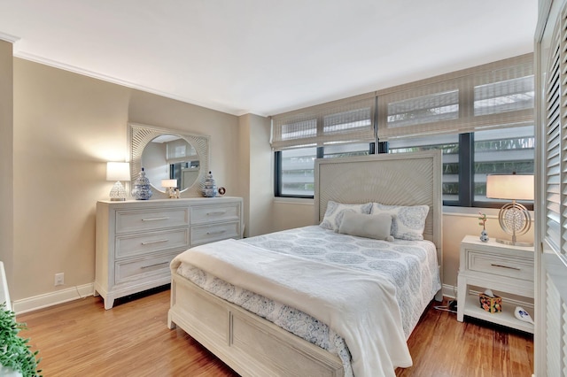 bedroom featuring light wood-style flooring and baseboards