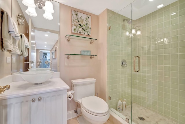 full bath featuring a stall shower, baseboards, toilet, an inviting chandelier, and vanity