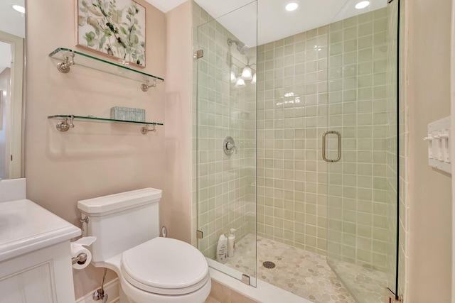 full bathroom featuring recessed lighting, a shower stall, toilet, and vanity