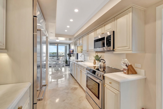 400 N Flagler Dr Unit 506, West Palm Beach, FL 33401 - kitchen featuring stainless steel appliances, recessed lighting, a sink, light countertops, and cream cabinets