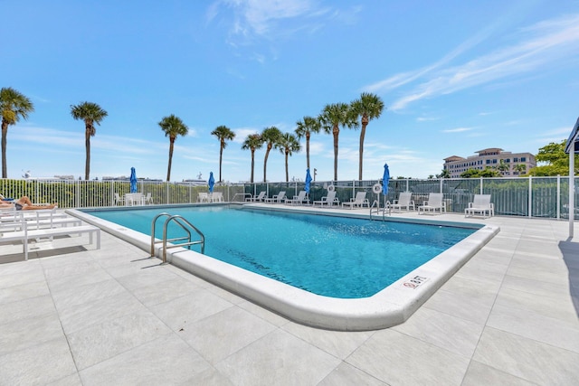 community pool featuring a patio area and fence