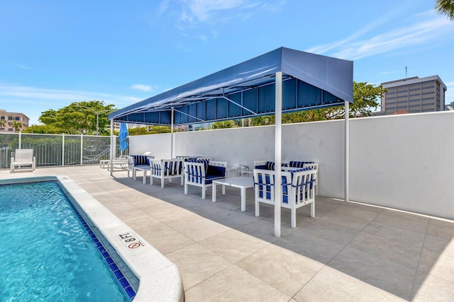 pool featuring a patio and fence