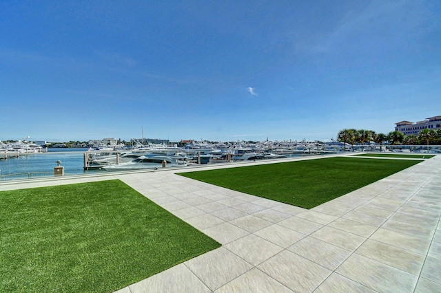 view of yard featuring a dock and a water view