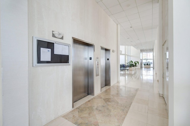 400 N Flagler Dr Unit 506, West Palm Beach, FL 33401 - hall with elevator, a drop ceiling, and a high ceiling