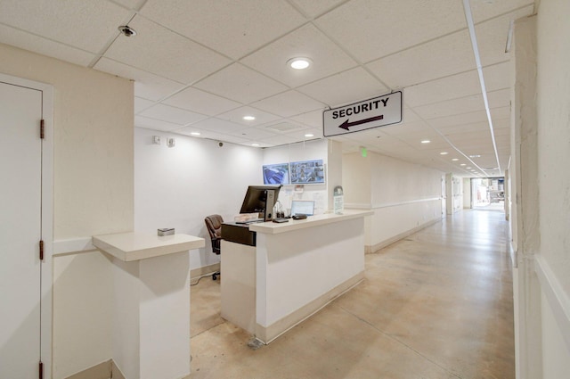 office with finished concrete flooring, a paneled ceiling, and recessed lighting