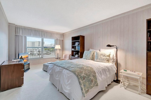 bedroom with crown molding, light carpet, and a textured ceiling