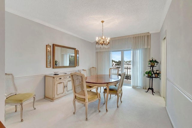 carpeted dining space featuring crown molding, a chandelier, and a textured ceiling