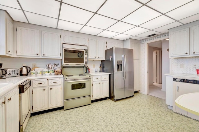 kitchen with electric stove, stainless steel fridge, dishwasher, and a paneled ceiling