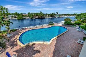 view of pool with a water view and a patio area