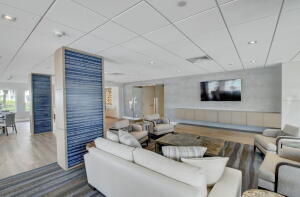 living room with hardwood / wood-style flooring and a paneled ceiling