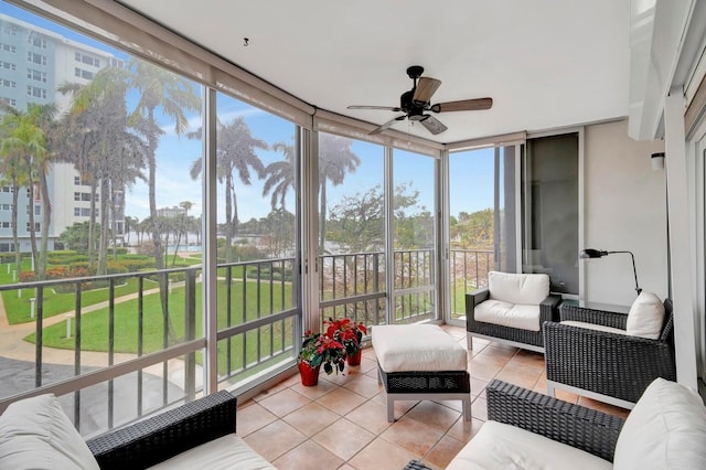 sunroom / solarium featuring ceiling fan