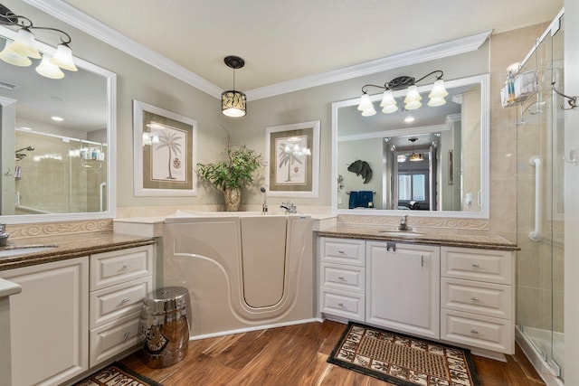 bathroom with a shower with door, vanity, ornamental molding, and hardwood / wood-style floors