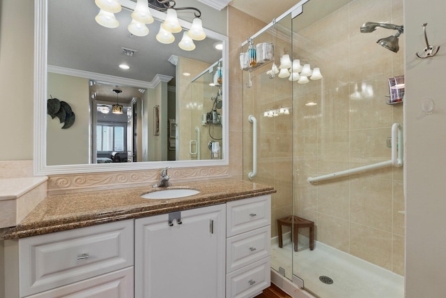 bathroom with walk in shower, ornamental molding, and vanity