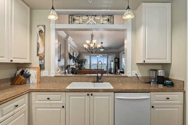 kitchen with crown molding, sink, white cabinets, and decorative light fixtures