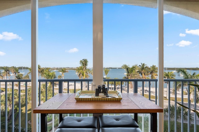 unfurnished sunroom featuring a water view and plenty of natural light