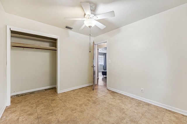 unfurnished bedroom featuring ceiling fan and a closet