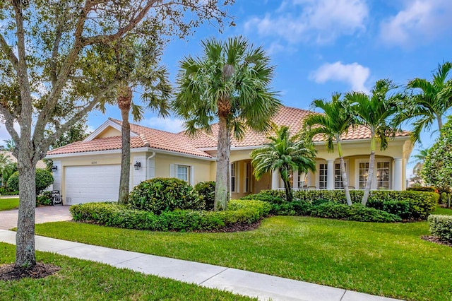 mediterranean / spanish-style home with a garage and a front yard