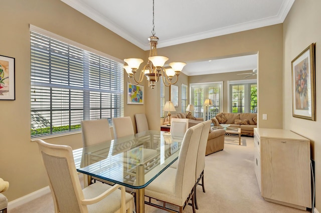 carpeted dining area with crown molding and ceiling fan with notable chandelier