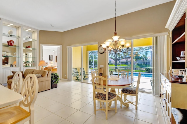 tiled dining room featuring an inviting chandelier, a wealth of natural light, and built in features