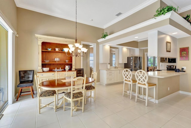 tiled dining room with an inviting chandelier, ornamental molding, sink, and a high ceiling