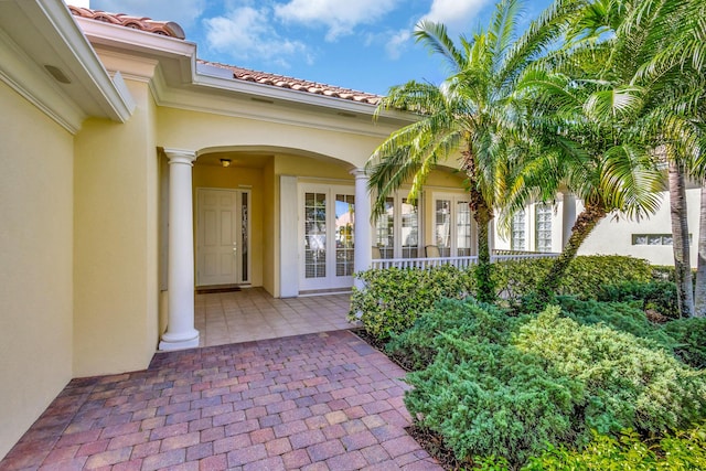 entrance to property featuring french doors and a patio