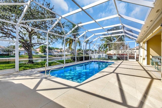 view of pool with a lanai, a patio, and a water view