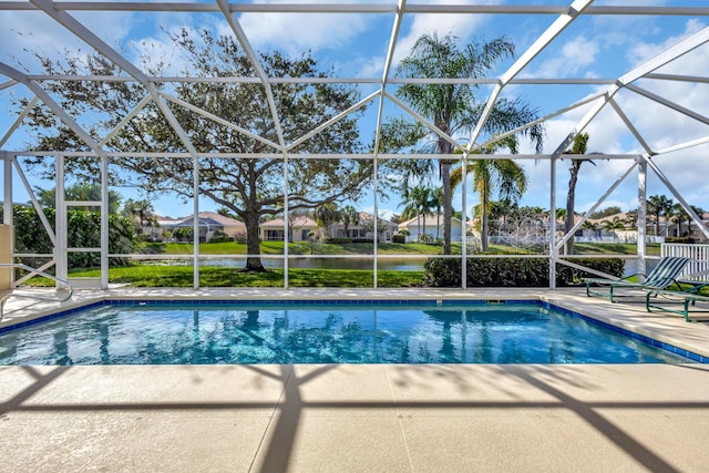 view of swimming pool featuring a lanai, a patio area, and a water view