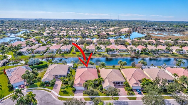 birds eye view of property with a water view