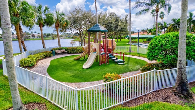 view of jungle gym with a yard and a water view