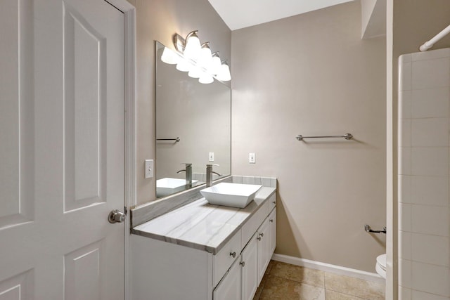 bathroom featuring vanity, tile patterned floors, and toilet